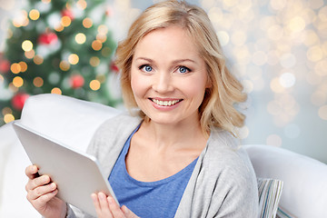 Image showing happy woman with tablet pc at christmas