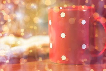 Image showing red polka dot tea cup on wooden table