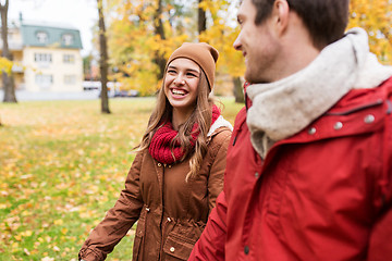 Image showing happy young couple walking in autumn park