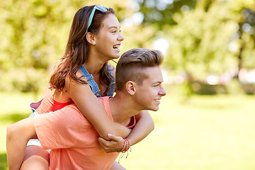 Image showing happy teenage couple having fun at summer park