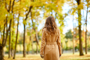 Image showing beautiful young woman walking in autumn park