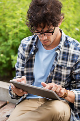 Image showing man in glasses with tablet pc computer outdoors