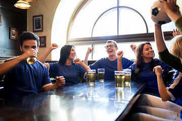 Image showing football fans or friends with beer at sport bar