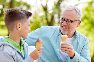 Image showing old man and boy eating ice cream at summer park