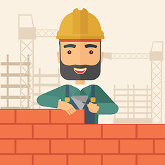 Image showing Builder man is building a brick wall.