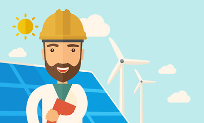 Image showing Man in solar panel and windmills.