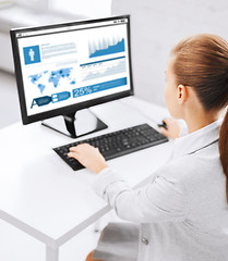 Image showing businesswoman with graphs on computer at office