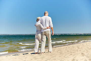 Image showing happy senior couple hugging on summer beach