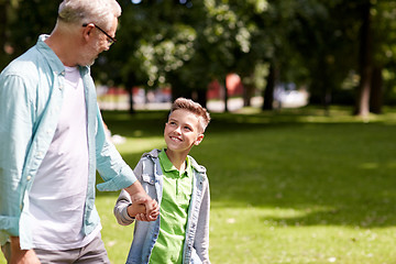 Image showing grandfather and grandson walking at summer park