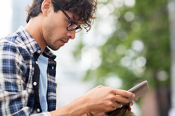 Image showing close up of man with tablet pc outdoors