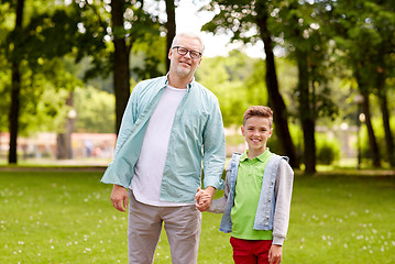 Image showing grandfather and grandson walking at summer park