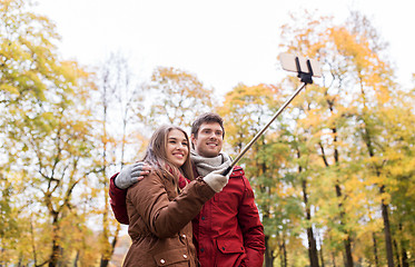 Image showing couple taking selfie by smartphone in autumn park