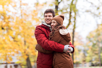 Image showing happy young couple hugging in autumn park