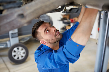 Image showing mechanic man or smith repairing car at workshop