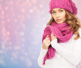 Image showing close up of woman in hat and scarf over lights