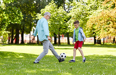 Image showing old man and boy playing football at summer park