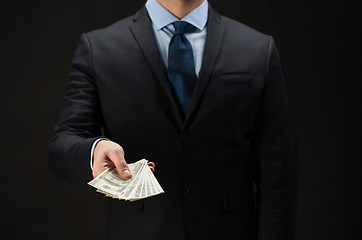 Image showing close up of businessman hands holding money