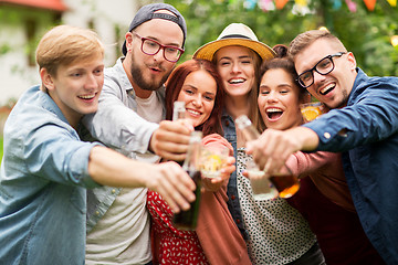 Image showing happy friends clinking glasses at summer garden