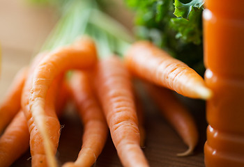 Image showing close up of carrot bunch on wooden table