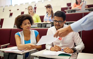 Image showing teacher giving tests to students at lecture