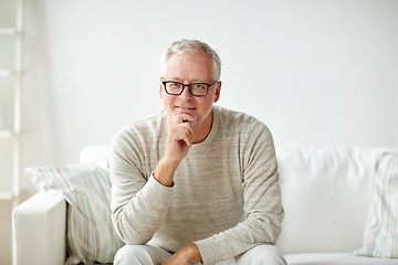 Image showing smiling senior man in glasses sitting on sofa