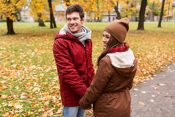 Image showing happy young couple walking in autumn park