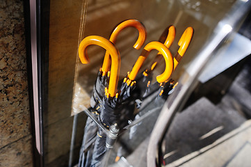 Image showing black umbrellas in a special basket