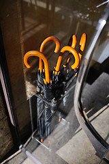 Image showing black umbrellas in a special basket