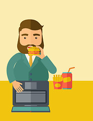 Image showing Young fat guy eating while at work.