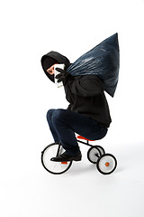 Image showing Robber goes on small bike