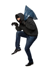 Image showing Robber sneaks in black mask