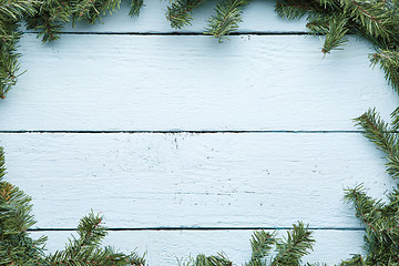 Image showing New year and christmas light blue wooden background with evergreen