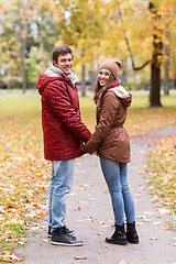 Image showing happy young couple walking in autumn park