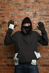 Image showing Burglar with banknotes in pockets