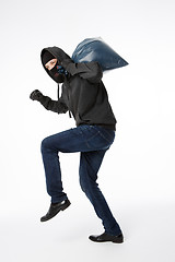 Image showing Thief slinking with blue bag