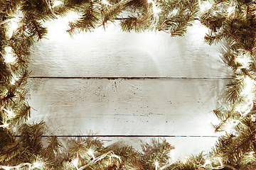 Image showing Xmas, new year wooden background with garland and fir tree