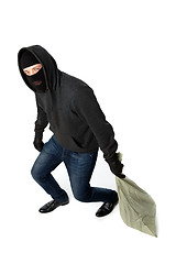 Image showing Thief in gloves carries bag