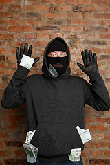 Image showing Robber with banknotes in pockets