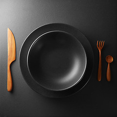 Image showing plate and cutlery on a black table