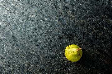 Image showing one juicy and ripe pear on a black background.