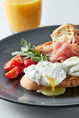 Image showing Eggs Benedict with ham and tomato