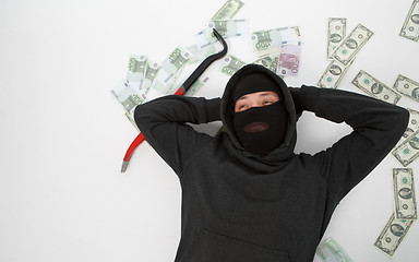 Image showing Burglar lying with passkey , money