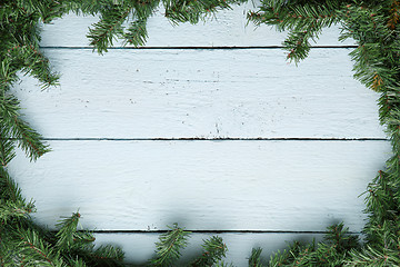 Image showing Wooden board with fir branches. Christmas and new year background