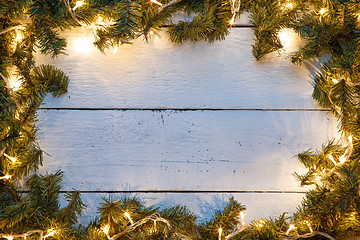 Image showing Christmas, new year wooden background with spruce branches and garland