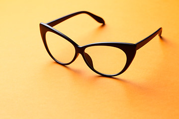 Image showing Brown glasses on orange background