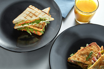 Image showing delicious breakfast sandwiches and orange juice
