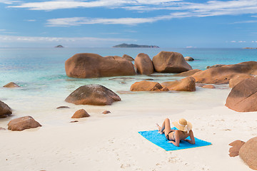 Image showing Woman sunbathing at Anse Lazio picture perfect beach on Praslin Island, Seychelles.