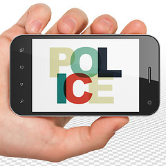 Image showing Law concept: Hand Holding Smartphone with Police on  display