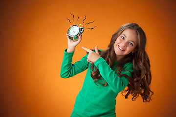 Image showing The cute cheerful little girl on orange background