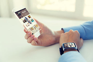 Image showing close up of hands with smart phone and watch